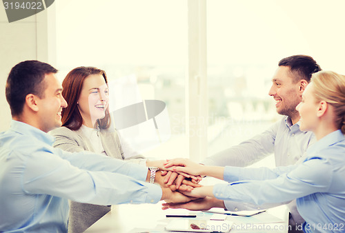 Image of business team celebrating victory in office