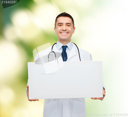 Image of smiling male doctor holding white blank board