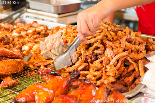 Image of close up of cook hands and snacks at street market