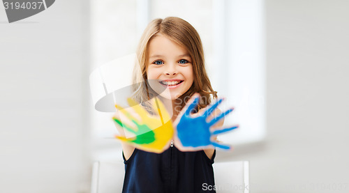 Image of girl showing painted hands