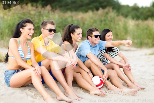 Image of group of happy friends on beach