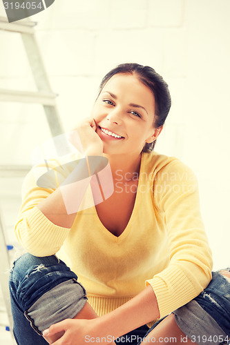 Image of lovely housewife making repairing works