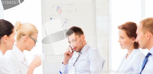 Image of stressed male boss on business meeting