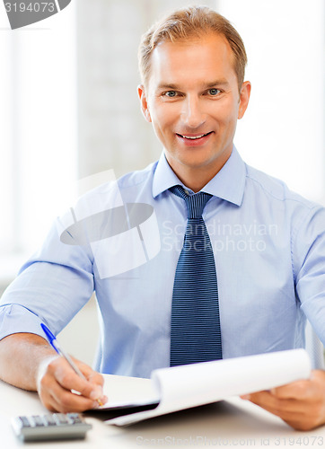 Image of businessman with notebook and calculator