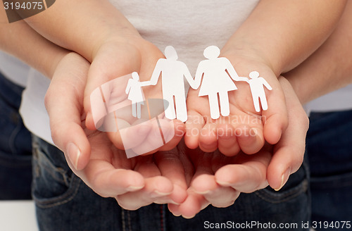 Image of close up of woman and girl hands with paper family