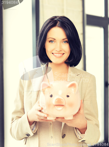 Image of lovely woman with piggy bank