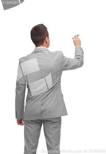 Image of businessman writing or drawing something imaginary