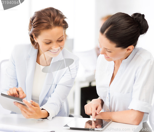 Image of business team working with tablet pc in office