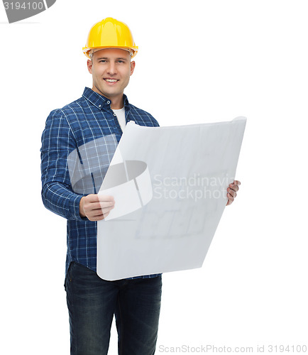 Image of smiling male builder in helmet with blueprint