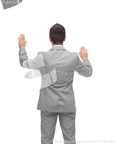 Image of businessman touching something imaginary