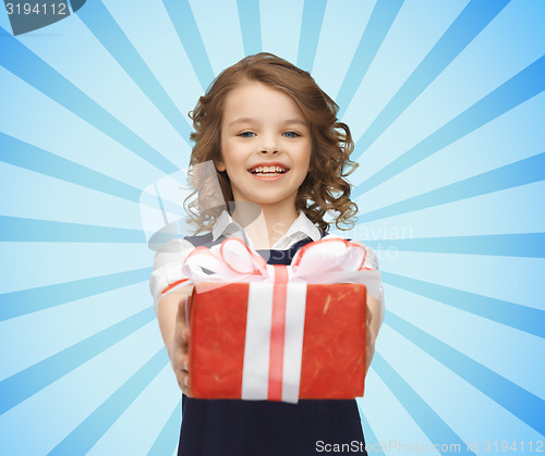 Image of happy girl with red gift box over blue