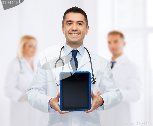 Image of smiling male doctor with tablet pc at hospital