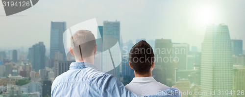 Image of close up of happy male gay couple hugging