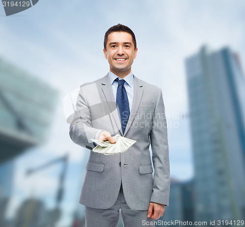 Image of smiling businessman with american dollar money