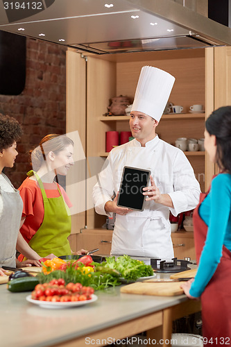 Image of happy women with chef and tablet pc in kitchen