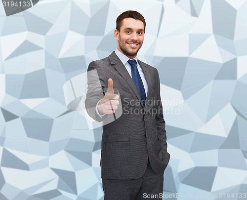 Image of handsome businessman showing thumbs up