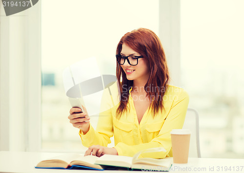 Image of smiling student girl with smartphone at school