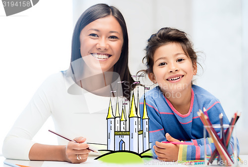 Image of happy mother and daughter drawing at home