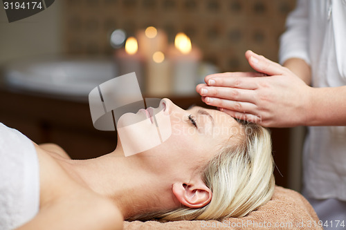 Image of close up of woman having face massage in spa