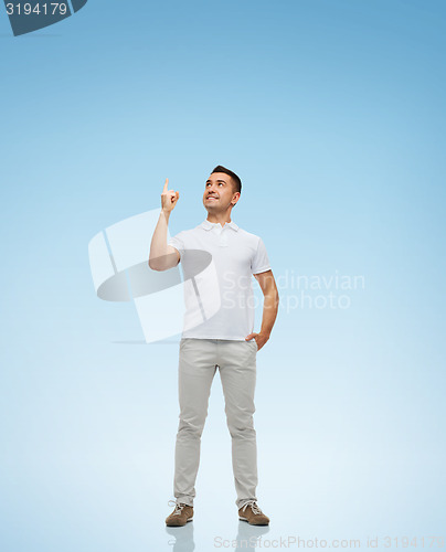 Image of smiling man pointing finger up