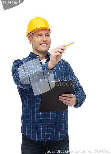 Image of smiling male builder in helmet with clipboard