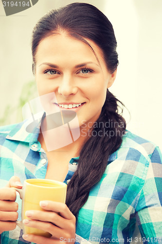 Image of lovely housewife with mug