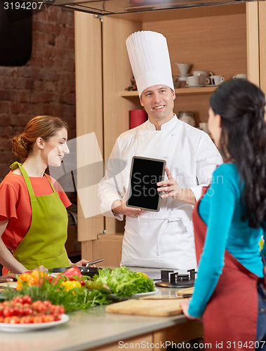 Image of happy women with chef and tablet pc in kitchen