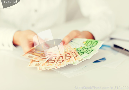 Image of woman hands with euro cash money