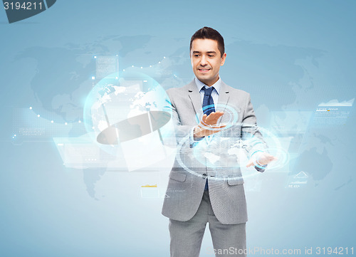 Image of happy businessman working with virtual screens