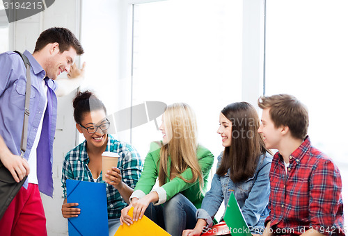 Image of students communicating and laughing at school