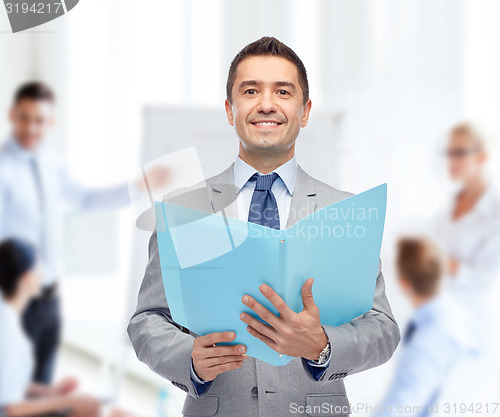 Image of happy businessman with open folder