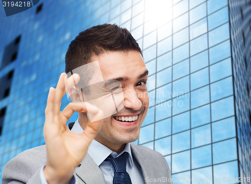 Image of happy businessman in suit showing ok hand sign