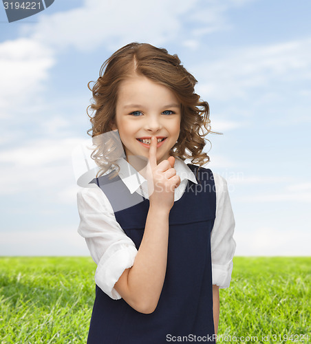 Image of happy girl showing hush gesture