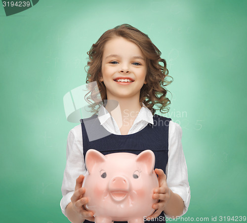 Image of happy girl holding piggy bank 