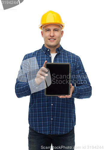 Image of smiling male builder in helmet with tablet pc