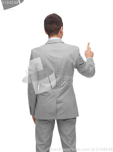 Image of businessman pointing finger or touching something