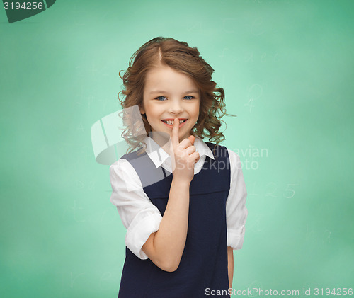 Image of happy girl showing hush gesture