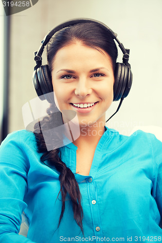 Image of happy teenage girl in big headphones