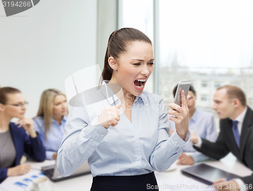 Image of screaming businesswoman with smartphone