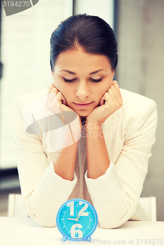 Image of businesswoman with clock