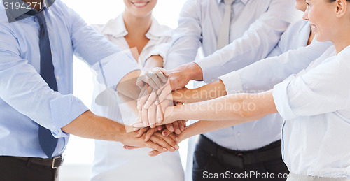 Image of business team celebrating victory in office