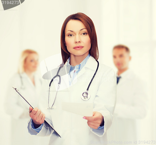 Image of calm female doctor with clipboard