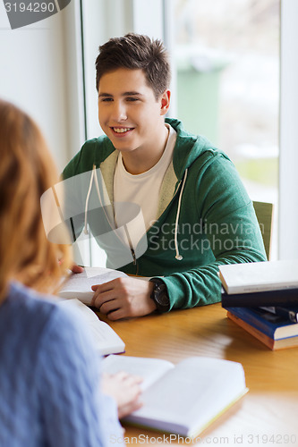 Image of students with books preparing to exam in library