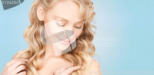 Image of beautiful young woman face with long wavy hair