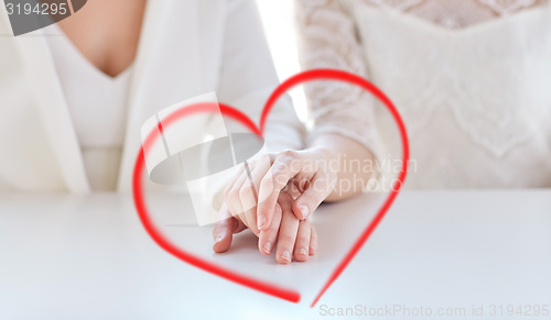 Image of close up of happy married lesbian couple hands
