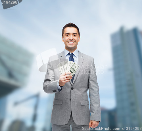 Image of smiling businessman with american dollar money