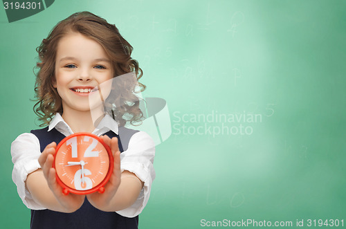 Image of happy girl with alarm clock 