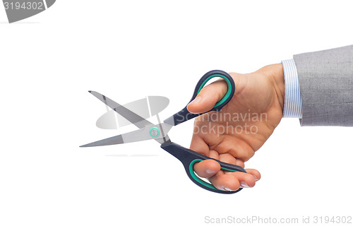 Image of close up of businessman hand holding scissors