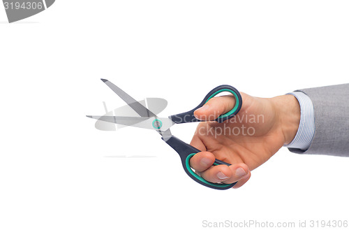 Image of close up of businessman hand holding scissors