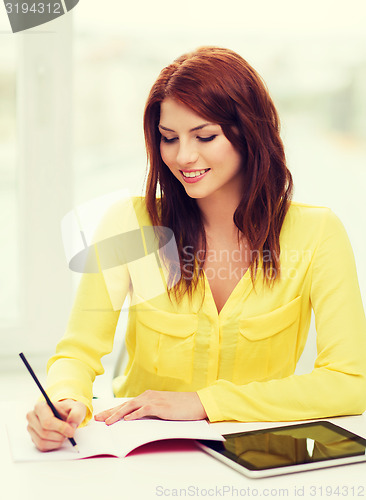 Image of student with tablet pc computer and notebook